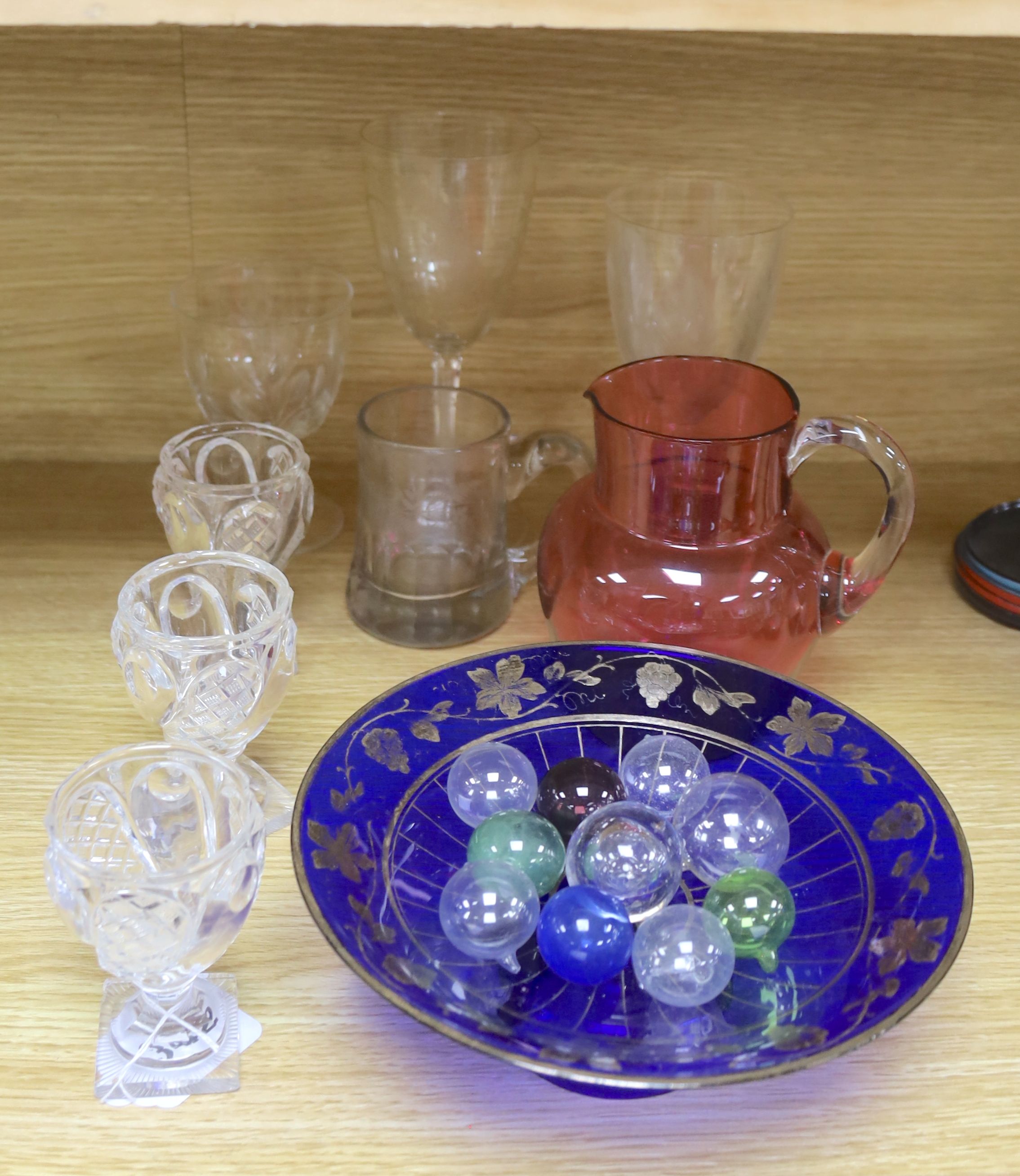 A Victorian cranberry glass jug and mixed glass